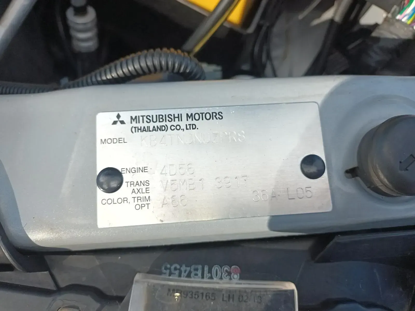 A Metal Vin Plate on a Car Hood With Mitsubishi Motors Details — South West 4WD Wreckers In Brisbane, QLD