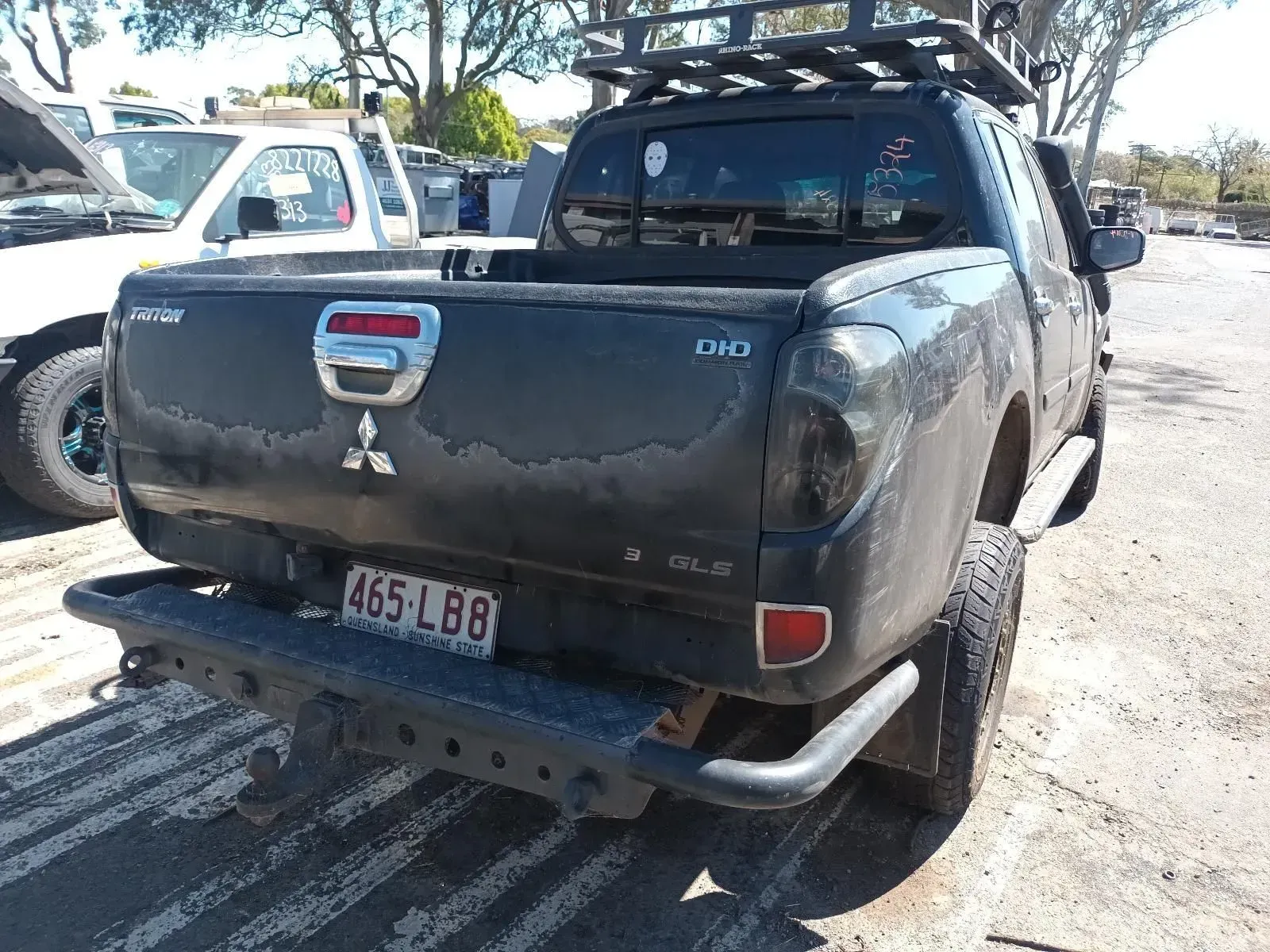 Black Mitsubishi Triton Truck With a Rack, Showing Signs of Wear — South West 4WD Wreckers In Brisbane, QLD