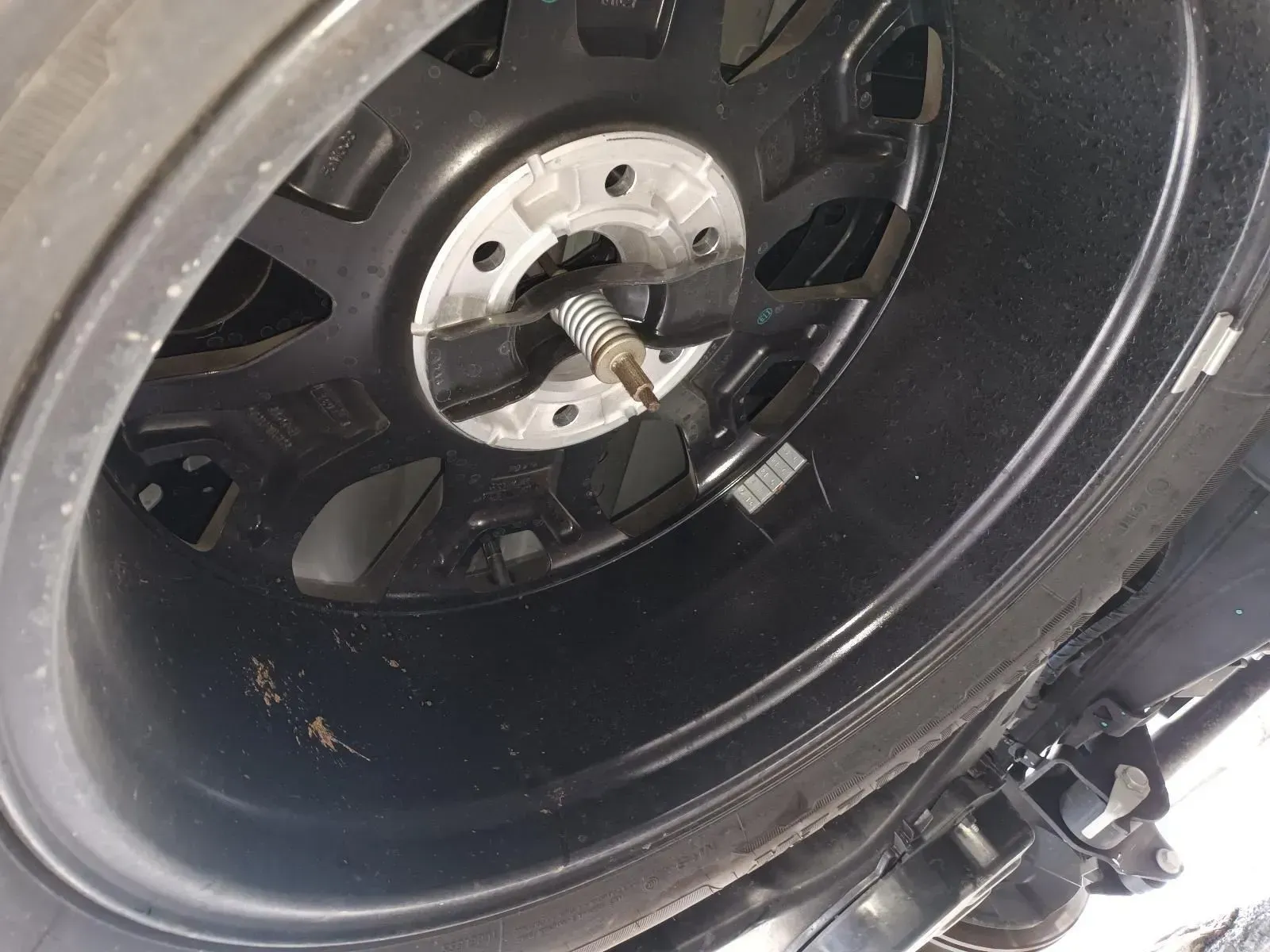 Black Car Tyre and Rim From an Underside View — South West 4WD Wreckers In Brisbane, QLD