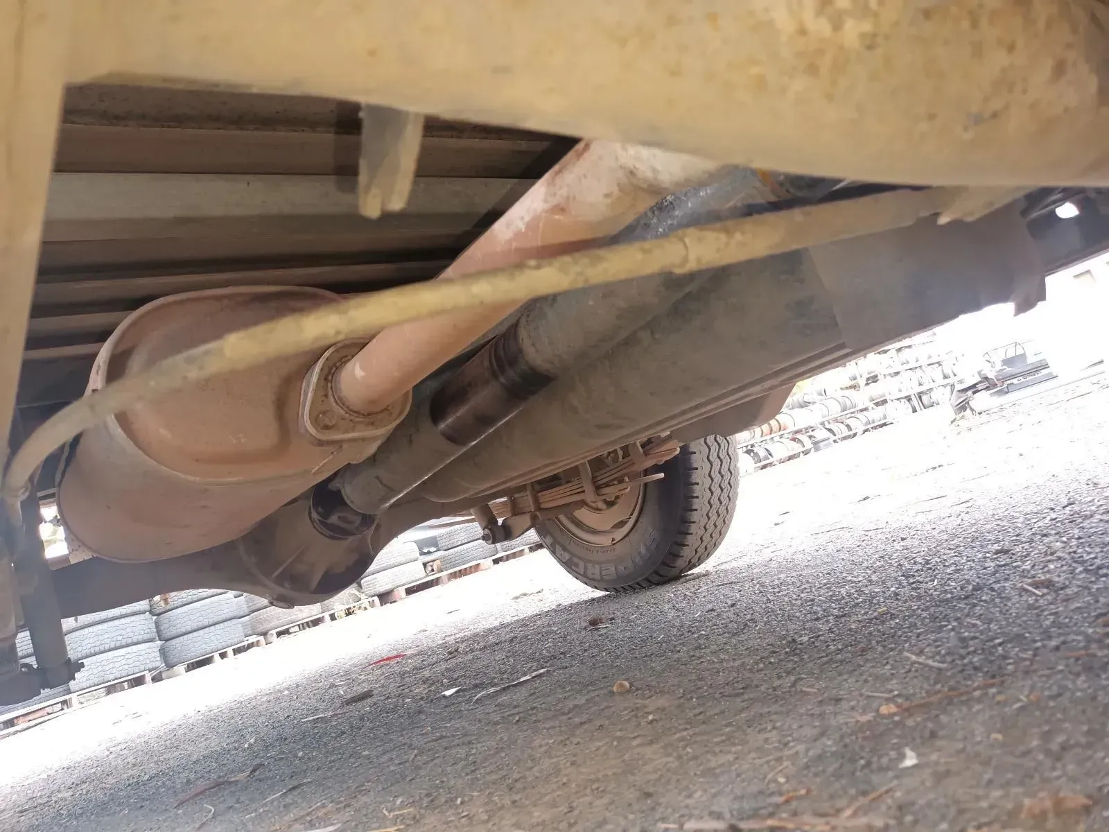 Underside of a Vehicle Showing Exhaust System, Rear Axle, and Tyre — South West 4WD Wreckers In Brisbane, QLD