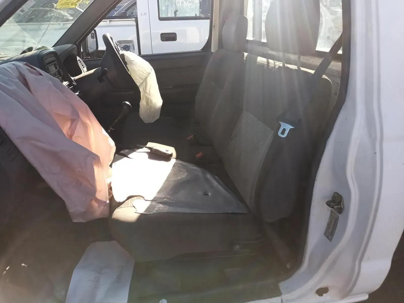 Interior of a White Pickup Truck With Deployed Airbags — South West 4WD Wreckers In Brisbane, QLD