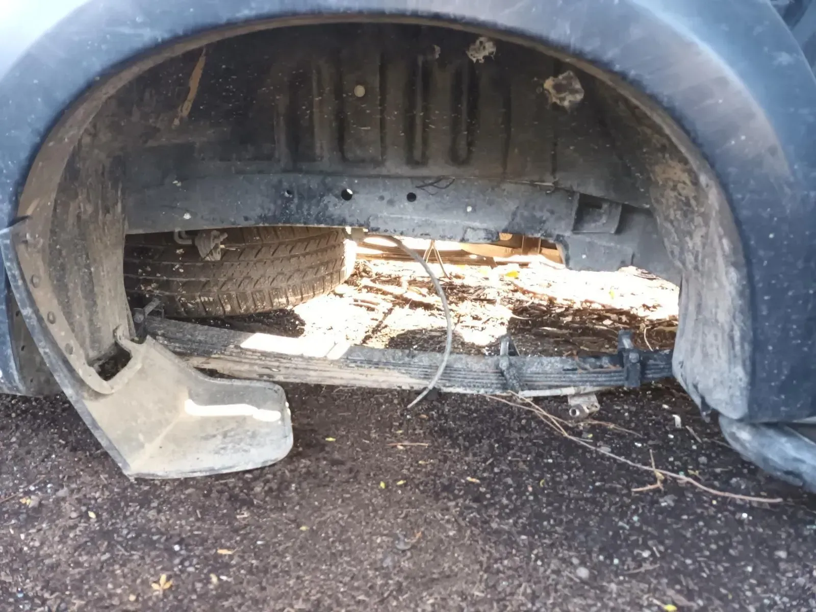 Underneath a Dark Vehicle Wheel Well Showing a Spare Tyre — South West 4WD Wreckers In Brisbane, QLD