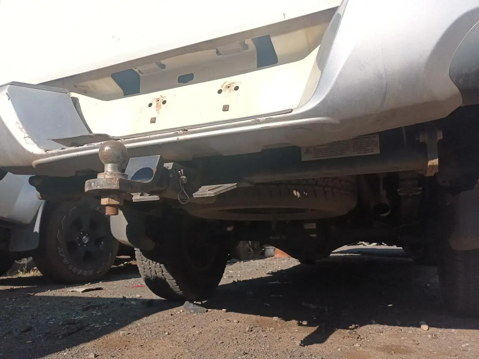 Rear of a White Pickup Truck With a Trailer Hitch and Exposed Mounting Area — South West 4WD Wreckers In Brisbane, QLD