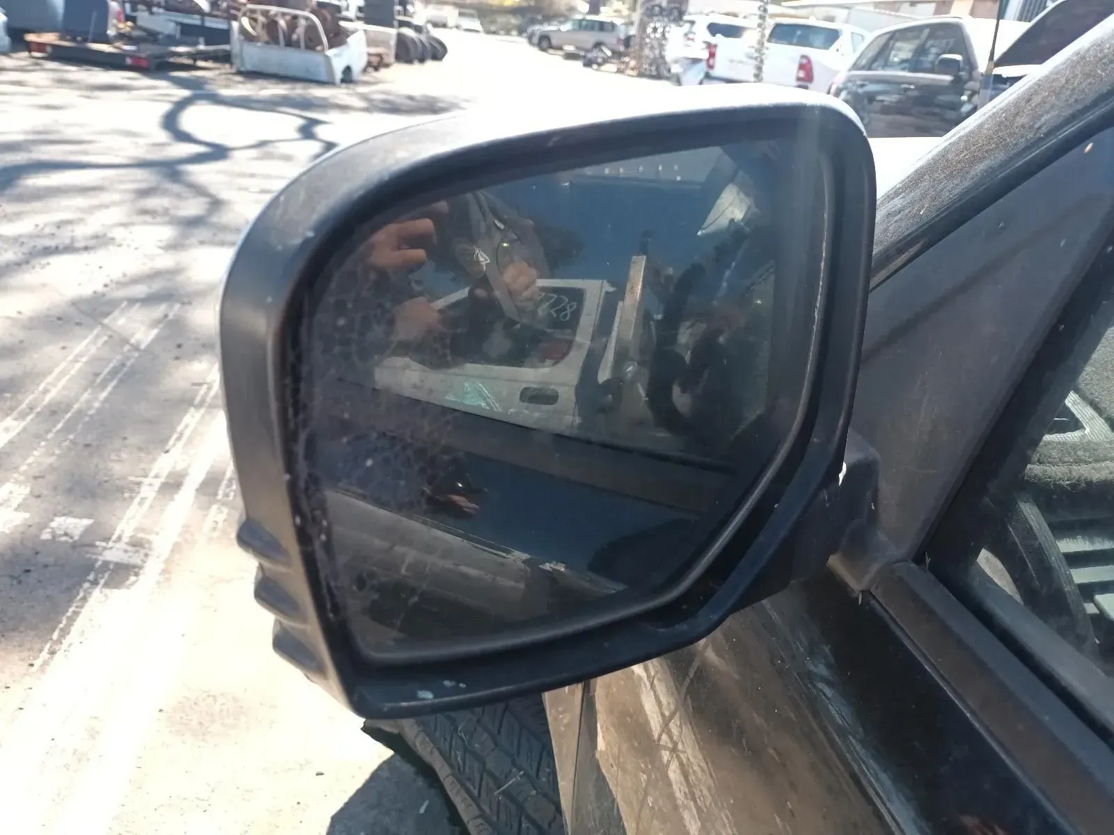 Black Side-view Mirror Reflecting a Vehicle Interior — South West 4WD Wreckers In Brisbane, QLD