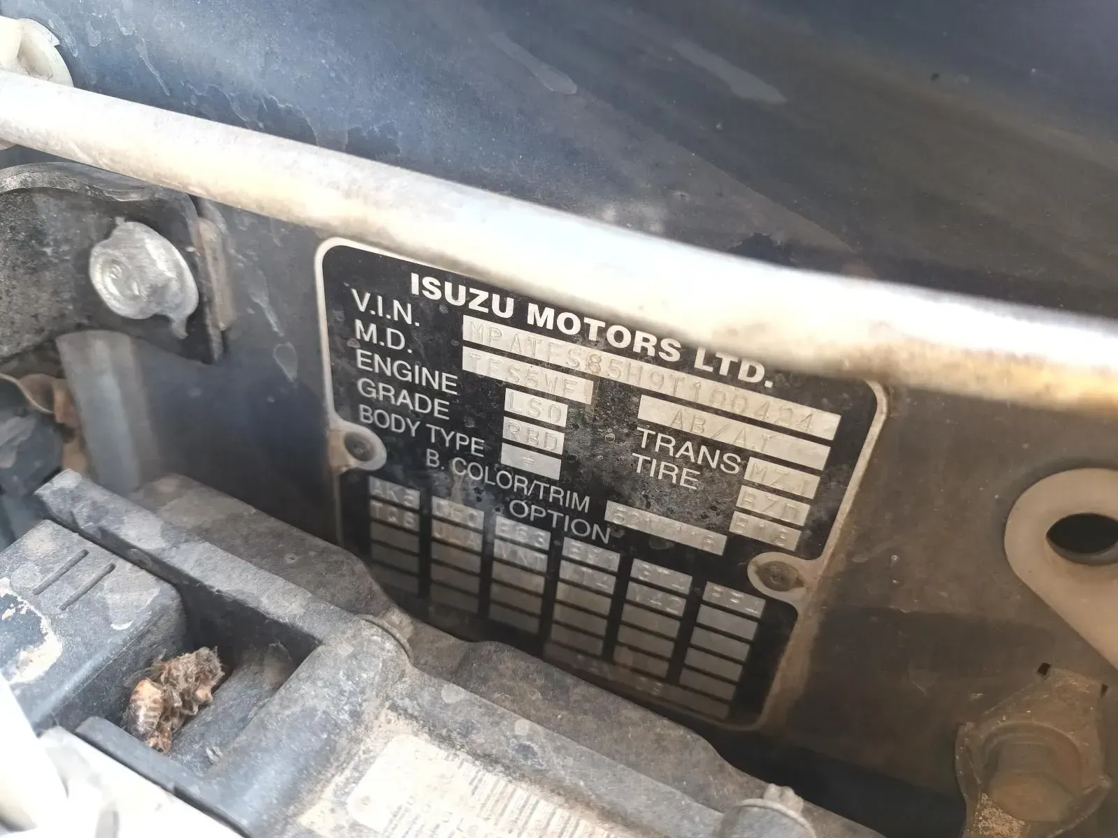 Close-up of an Isuzu Vehicle Identification Plate Attached Inside the Engine Bay — South West 4WD Wreckers In Brisbane, QLD