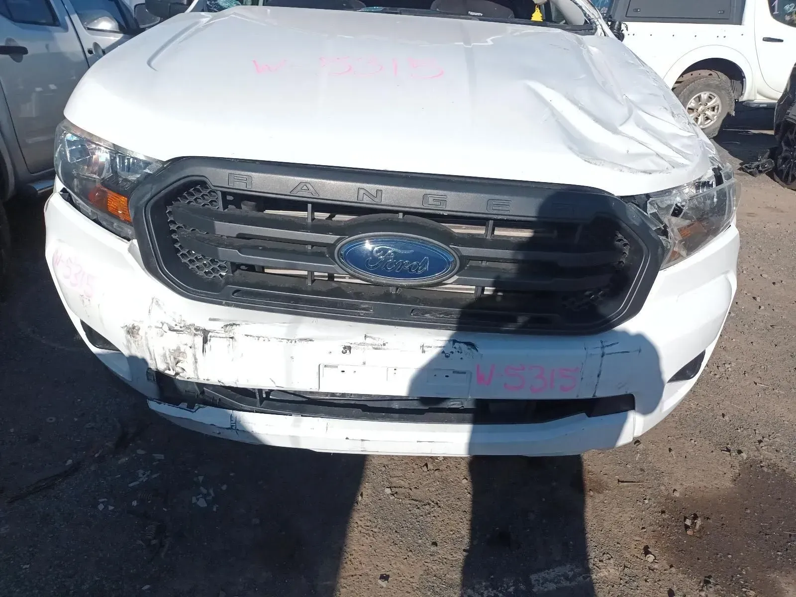 White Ford Ranger Truck With Front-end Damage, Including a Dented Hood — South West 4WD Wreckers In Brisbane, QLD