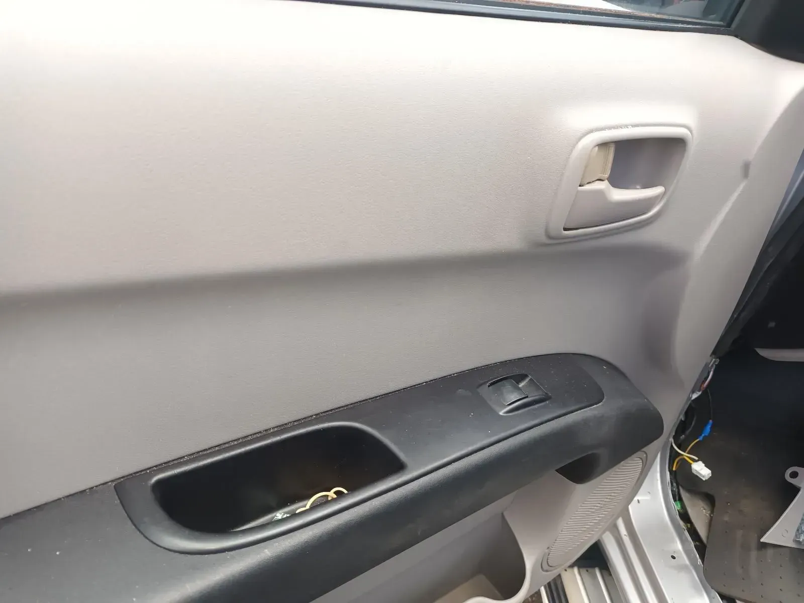 Gray Car Door Panel With Black Window Controls, Handle, and Small Storage — South West 4WD Wreckers In Brisbane, QLD