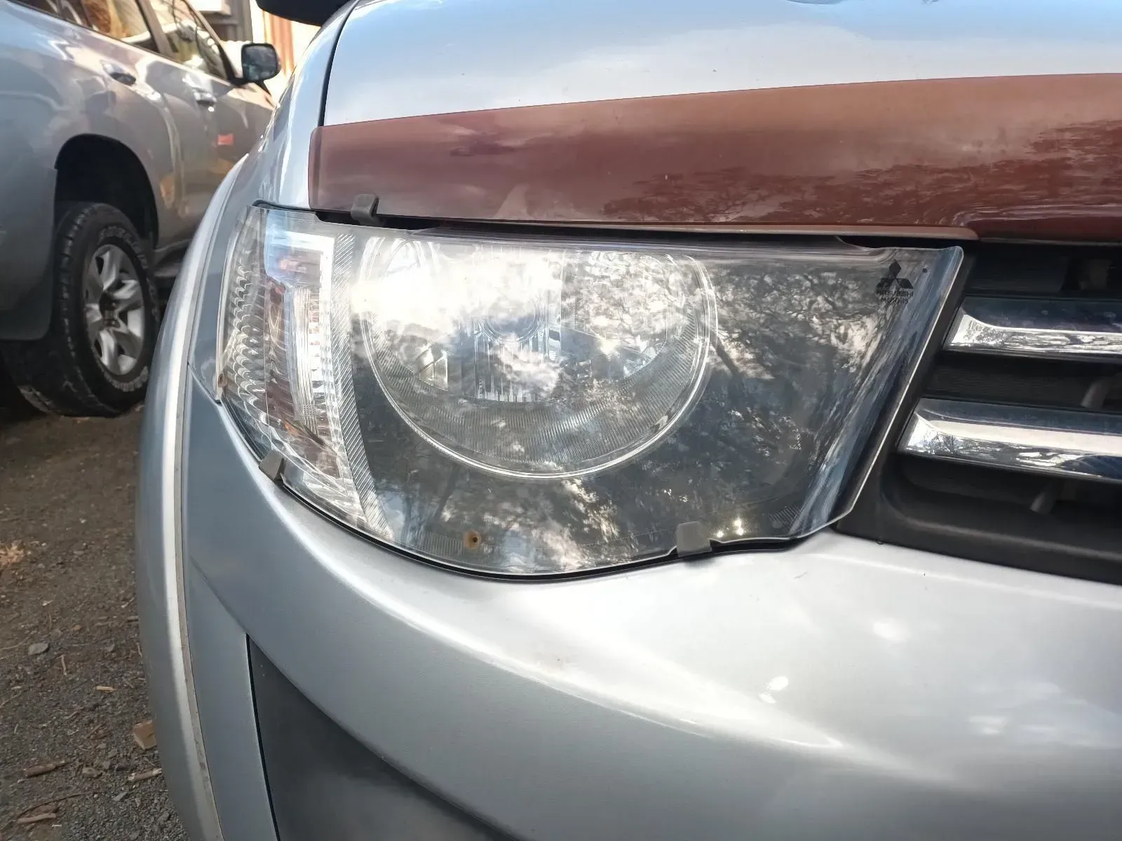 Silver Car Headlight With Brown Hood Deflector — South West 4WD Wreckers In Brisbane, QLD