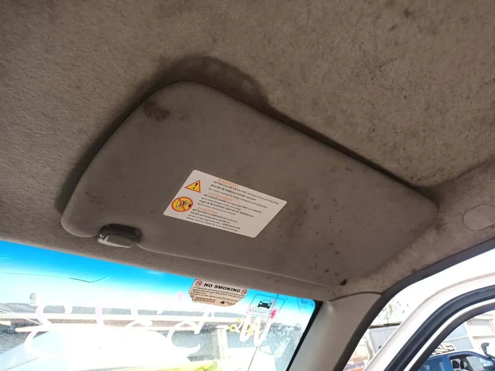 Gray Car Sun Visor With Warning Label, Attached to the Vehicle's Interior Ceiling — South West 4WD Wreckers In Brisbane, QLD
