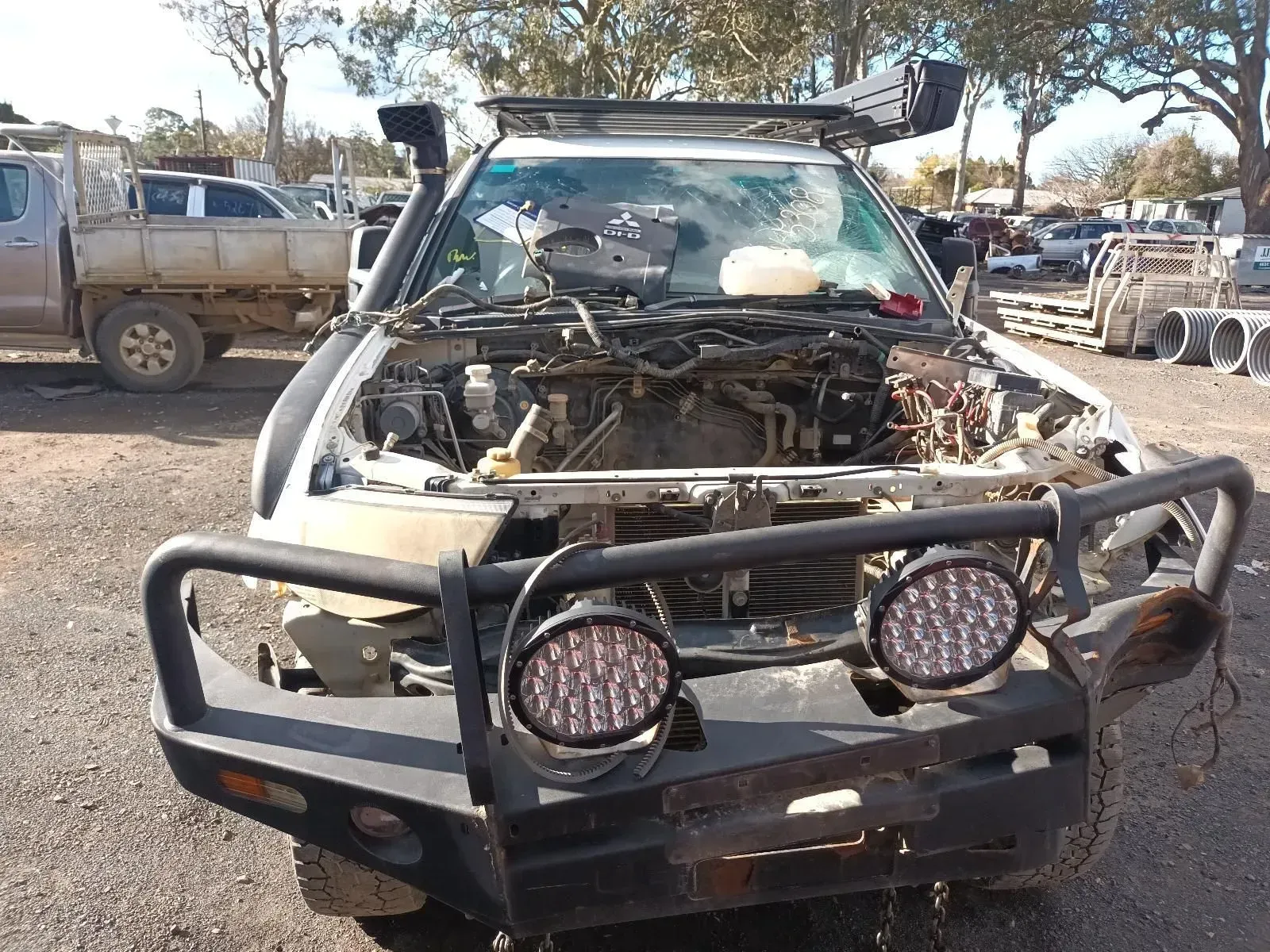 Damaged White Suv With Missing Engine Parts in a Junkyard — South West 4WD Wreckers In Brisbane, QLD