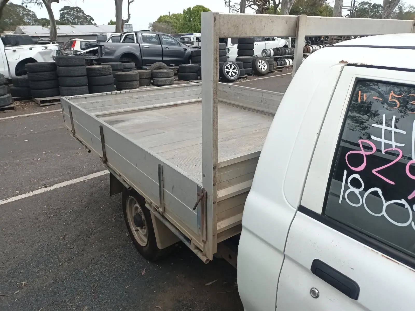 White Flatbed Truck in a Junkyard — South West 4WD Wreckers In Brisbane, QLD