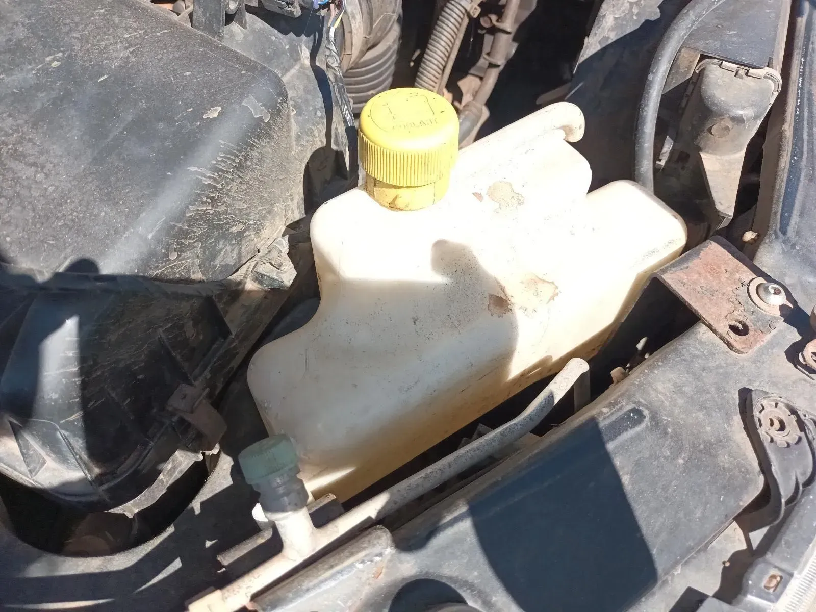 Yellow Cap on a Yellowish Coolant Reservoir in a Car Engine Bay — South West 4WD Wreckers In Brisbane, QLD