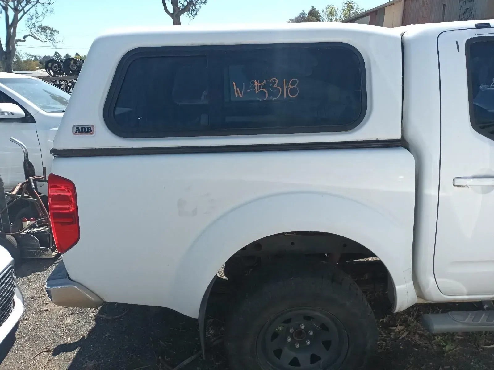 White Pickup Truck With a Camper Shell, Parked Outdoors — South West 4WD Wreckers In Brisbane, QLD