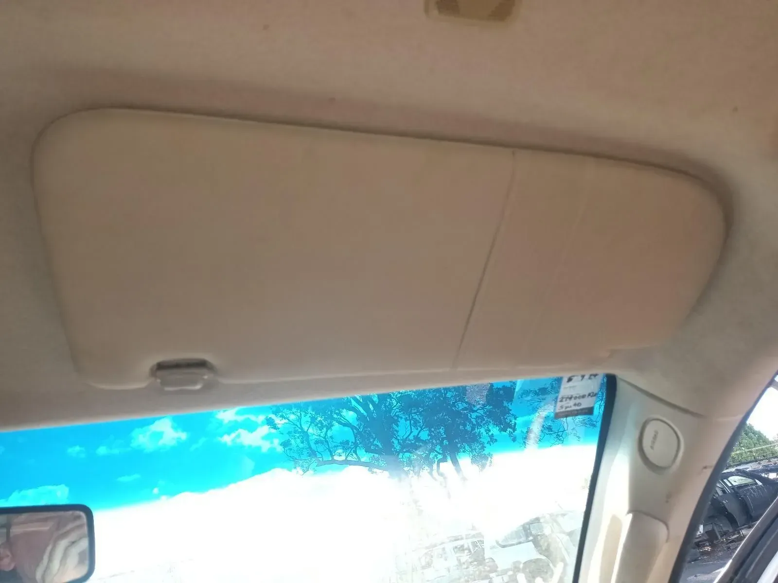 Beige Car Sun Visor in the Up Position, Partially Obscuring a Windshield — South West 4WD Wreckers In Brisbane, QLD