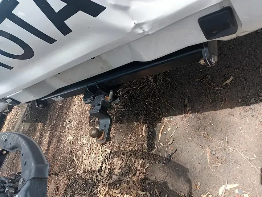 A White Toyota Truck is Parked on the Side of the Road — South West 4WD Wreckers In Brisbane, QLD