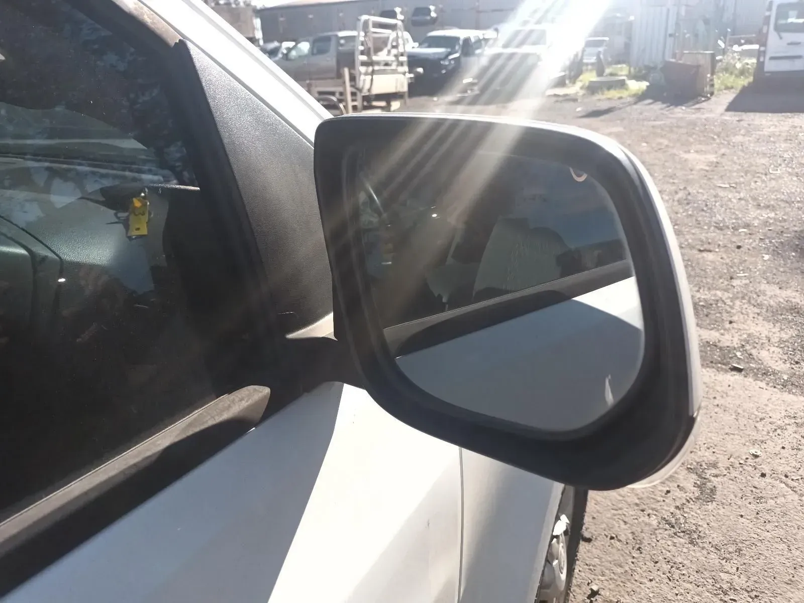 Side View Mirror on a White Car, Reflecting Sunlight and Surroundings — South West 4WD Wreckers In Brisbane, QLD