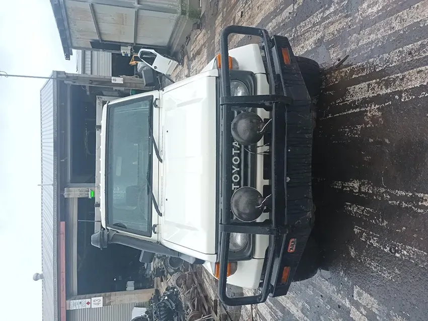 A White Toyota Truck is Parked in Front of a Building — South West 4WD Wreckers In Brisbane, QLD