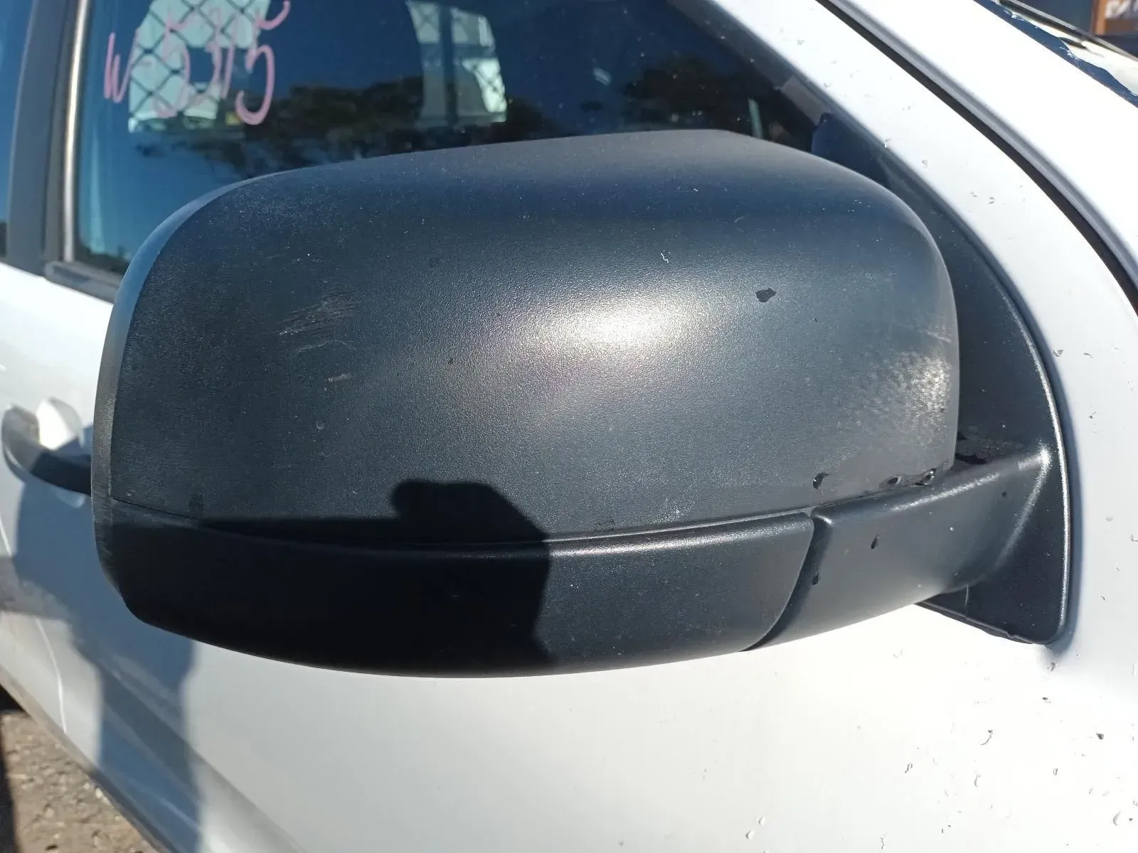 Black Side-view Mirror on a White Car; It is Outdoors — South West 4WD Wreckers In Brisbane, QLD