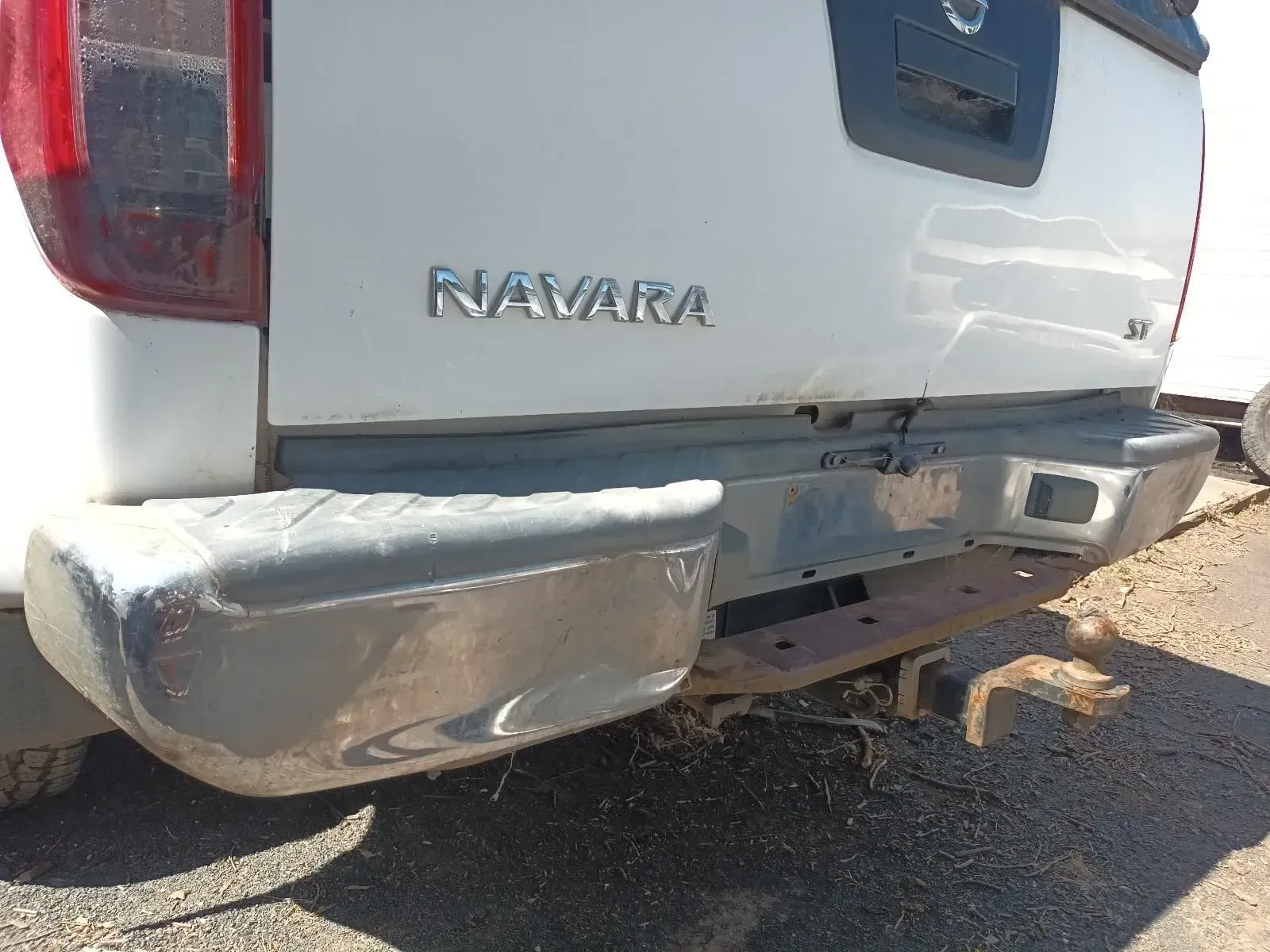 White Nissan Navara Truck Rear, Damaged Bumper With Visible Tow Hitch — South West 4WD Wreckers In Brisbane, QLD