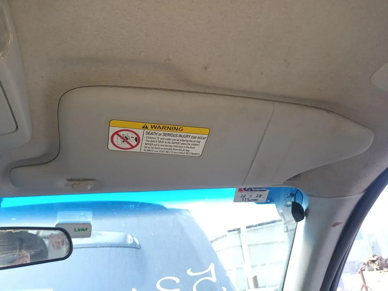 Car Interior: a Gray Sun Visor With Warning Label — South West 4WD Wreckers In Brisbane, QLD