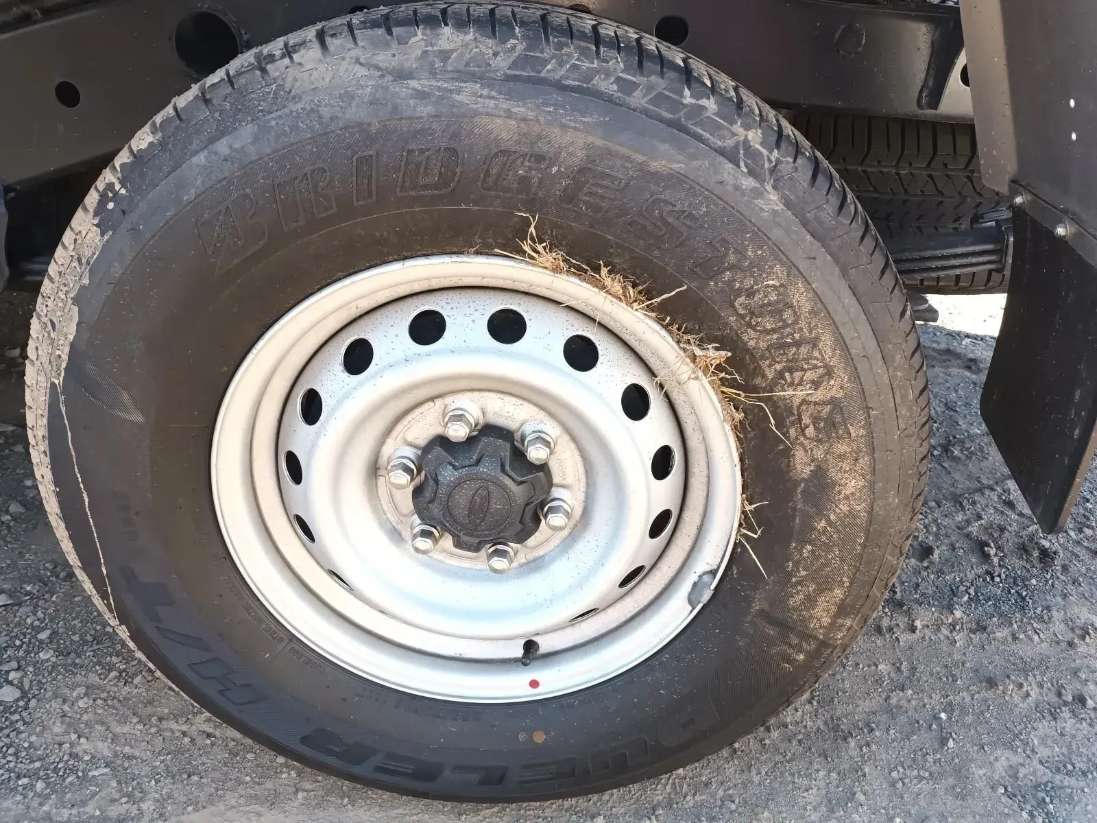 Close-up of a Truck Tyre With a White Rim, Covered in Sand — South West 4WD Wreckers In Brisbane, QLD
