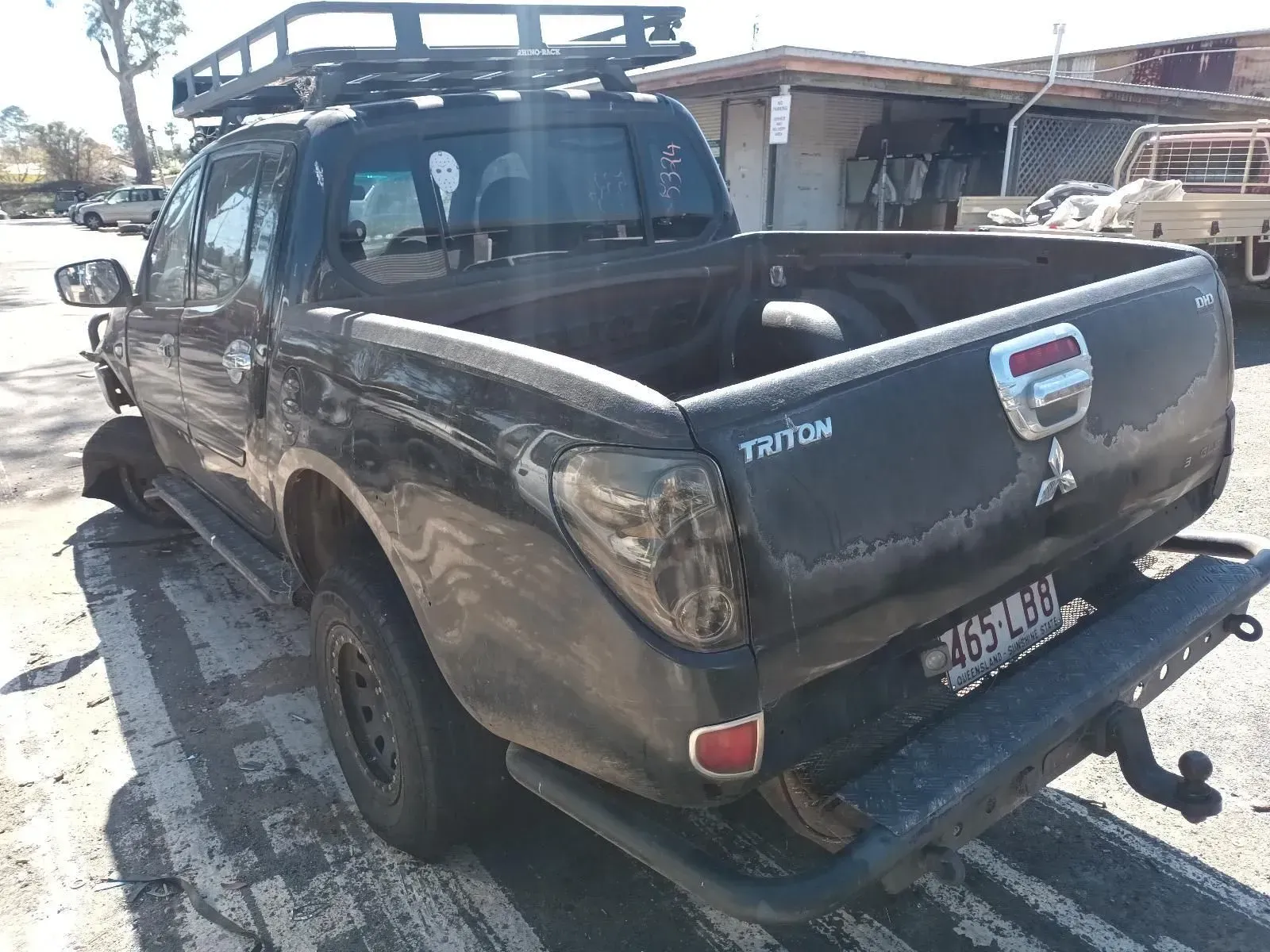 Black Mitsubishi Triton Pickup Truck Parked on a Concrete Surface — South West 4WD Wreckers In Brisbane, QLD