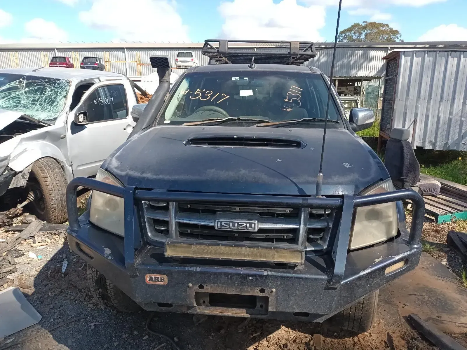 Dark Blue Isuzu Truck With a Bull Bar, in a Salvage Yard — South West 4WD Wreckers In Brisbane, QLD