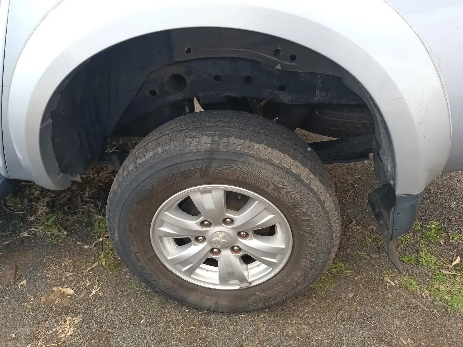 Silver Truck Wheel With a Tyre on a Dirt Road — South West 4WD Wreckers In Brisbane, QLD