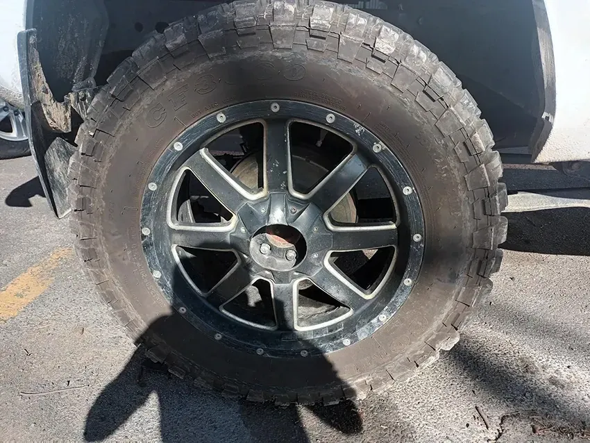 A Close Up of a Tire on a Truck in a Parking Lot — South West 4WD Wreckers In Brisbane, QLD