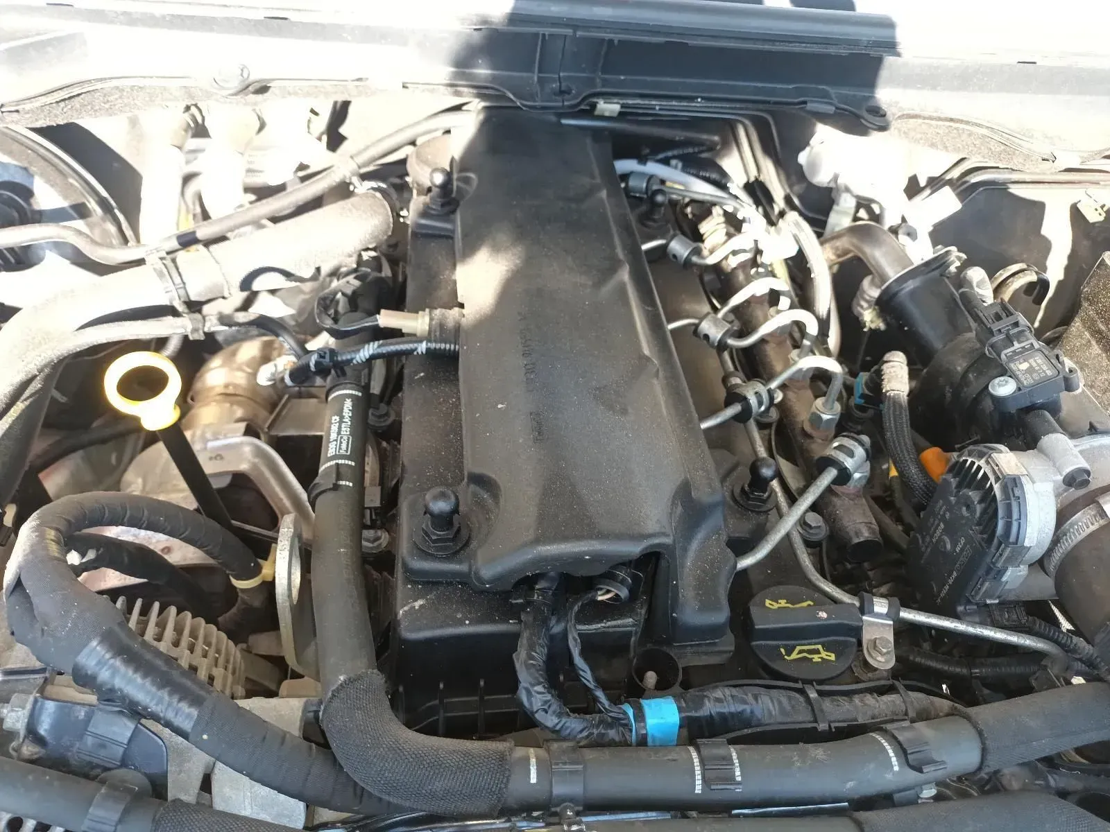 Car Engine With Black Cover, Tubes, and Hoses. Sunlight and Shadows — South West 4WD Wreckers In Brisbane, QLD