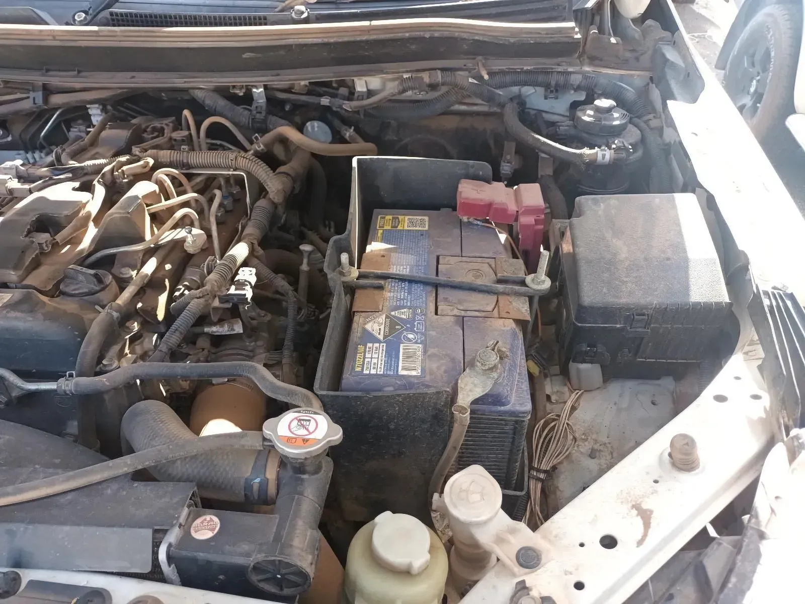 Car Engine Compartment With Battery, Wires, and Various Engine Components — South West 4WD Wreckers In Brisbane, QLD