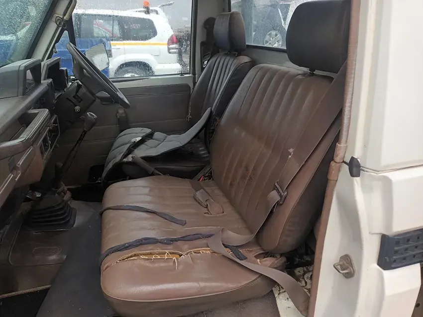 The Interior of a White Truck With Brown Seats and a Broken Seat Belt — South West 4WD Wreckers In Brisbane, QLD