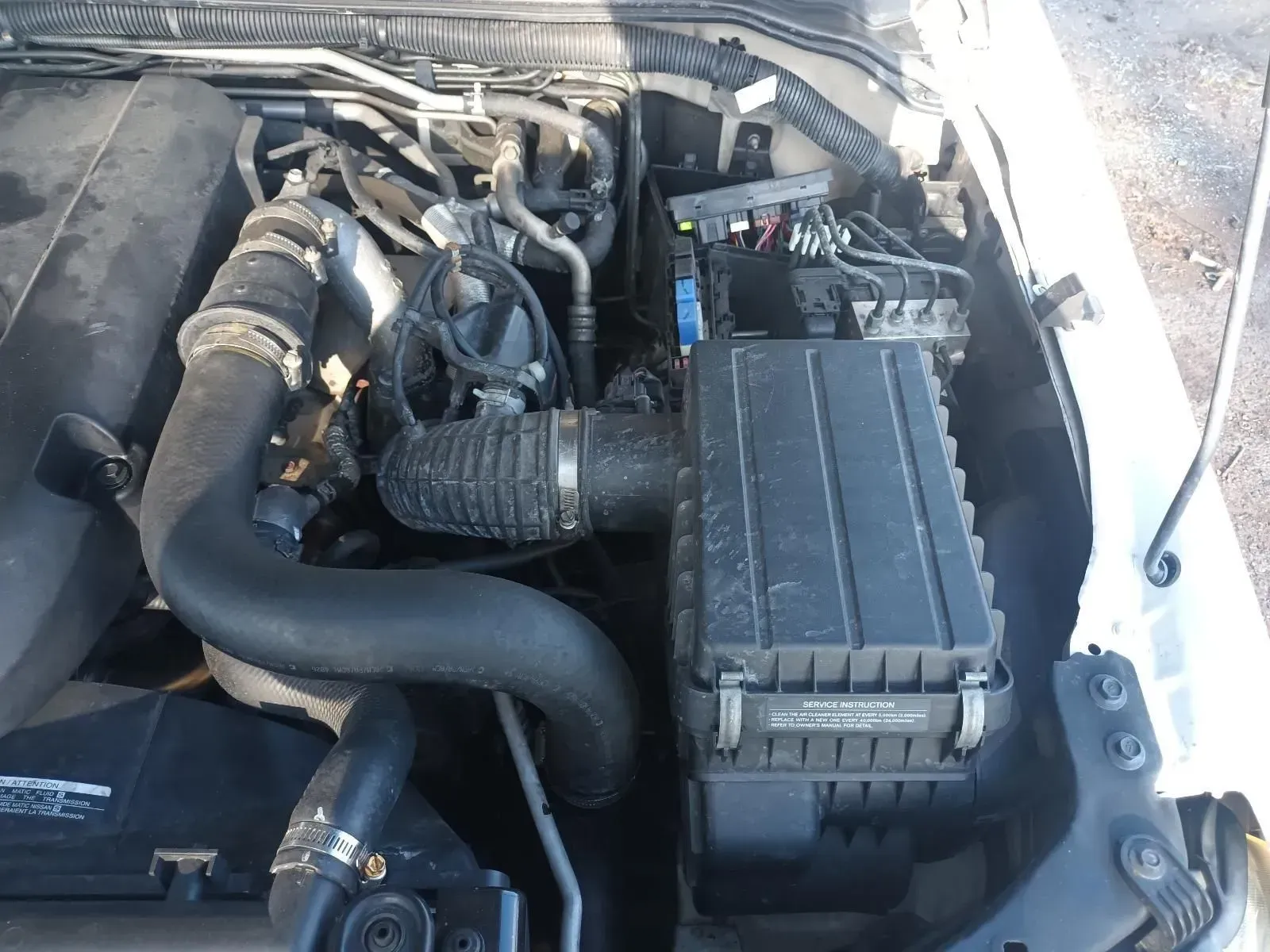 An Open Car Engine Bay With Black Components — South West 4WD Wreckers In Brisbane, QLD