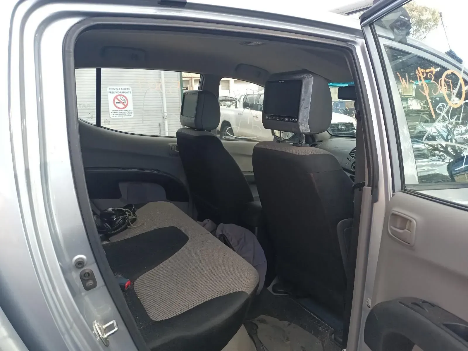 Silver Pickup Truck Interior With Rear Seats, Headrest Screens, and Open Door — South West 4WD Wreckers In Brisbane, QLD