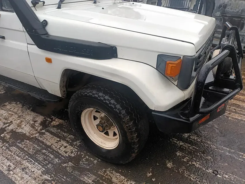A White Jeep With a Snorkel on the Hood is Parked on the Side of the Road — South West 4WD Wreckers In Brisbane, QLD