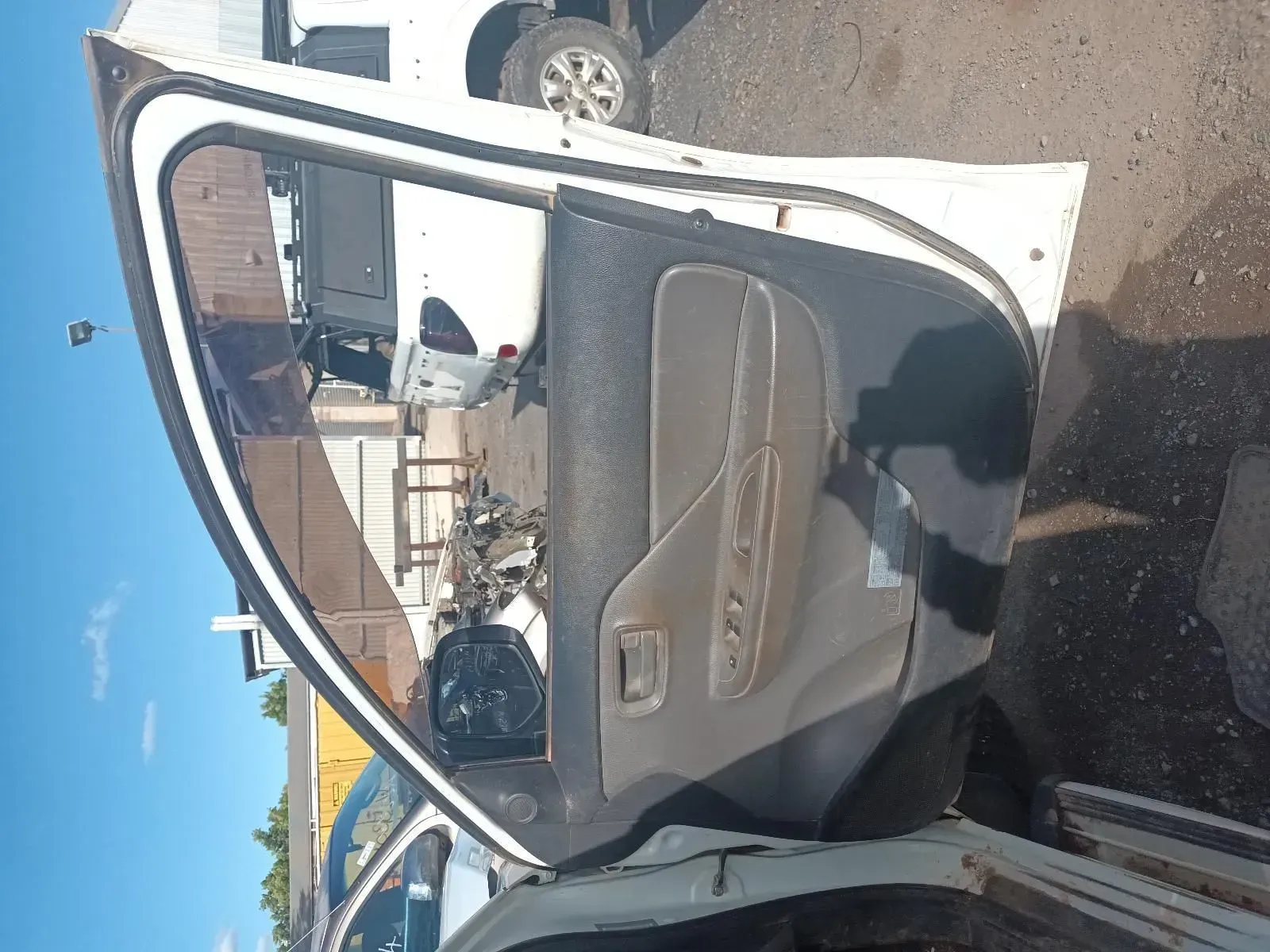 White Car Door With Tan Interior, Open in a Junkyard — South West 4WD Wreckers In Brisbane, QLD
