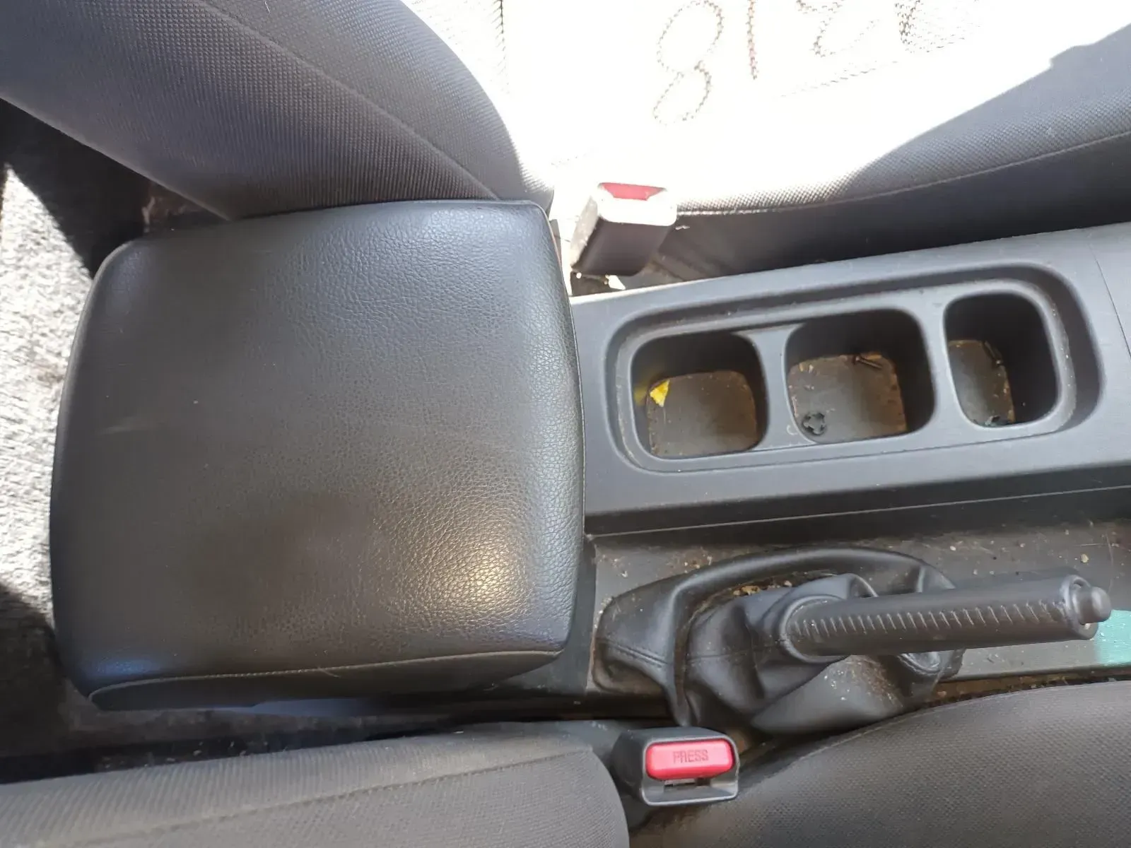 Black Car Interior: Center Console With Armrest, Cup Holders, and Handbrake — South West 4WD Wreckers In Brisbane, QLD