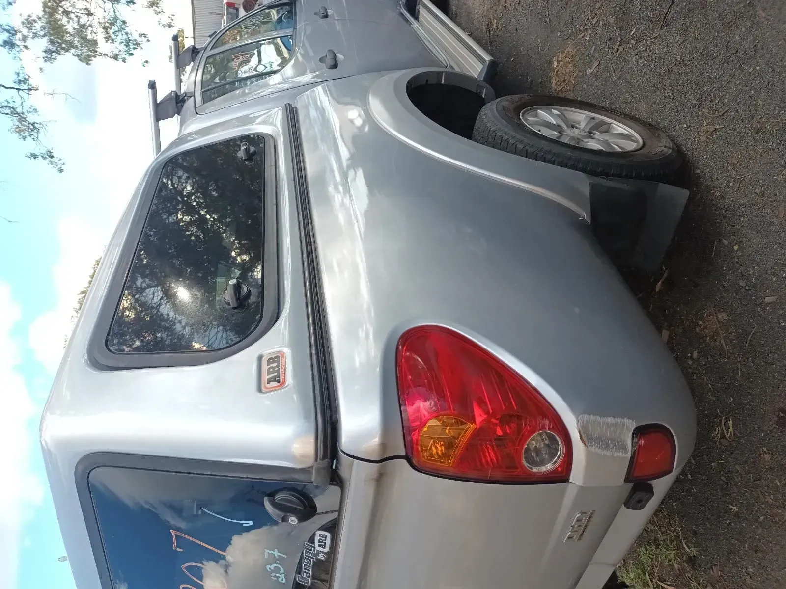 Silver Pickup Truck With a Canopy Parked Outside — South West 4WD Wreckers In Brisbane, QLD