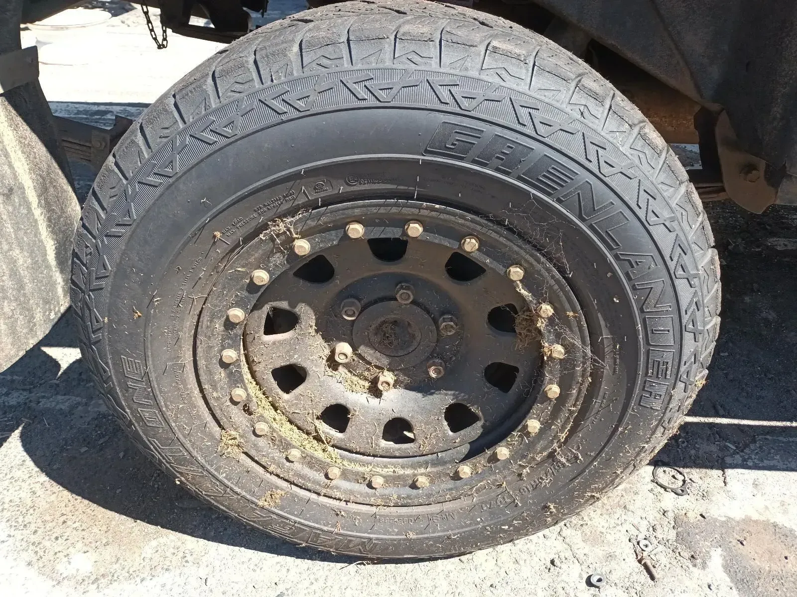 Black Off-road Tyre and Rim Covered in Dirt, Viewed From the Side — South West 4WD Wreckers In Brisbane, QLD