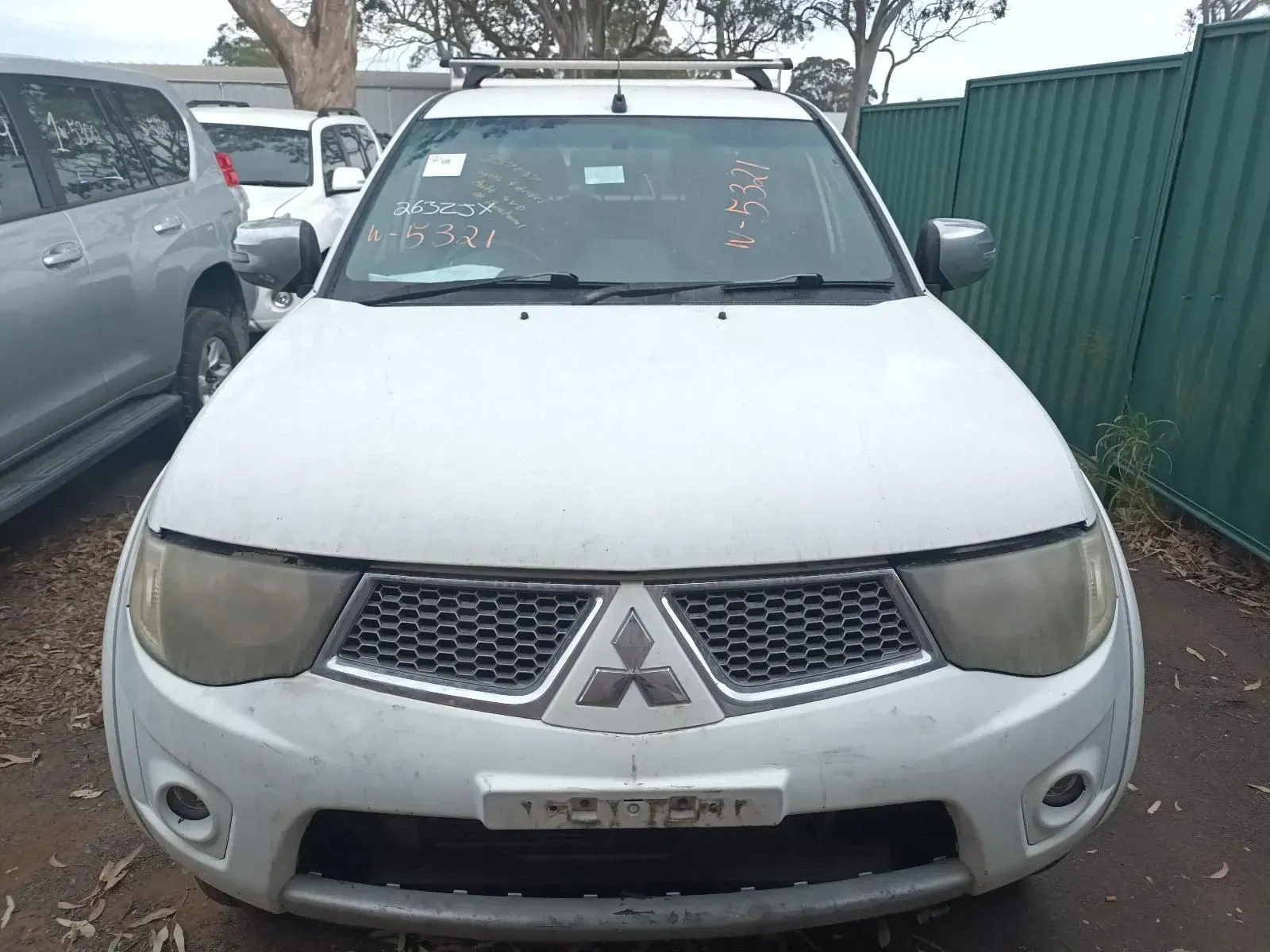 White Mitsubishi Triton Pickup Truck Parked Outdoors, Front View — South West 4WD Wreckers In Brisbane, QLD