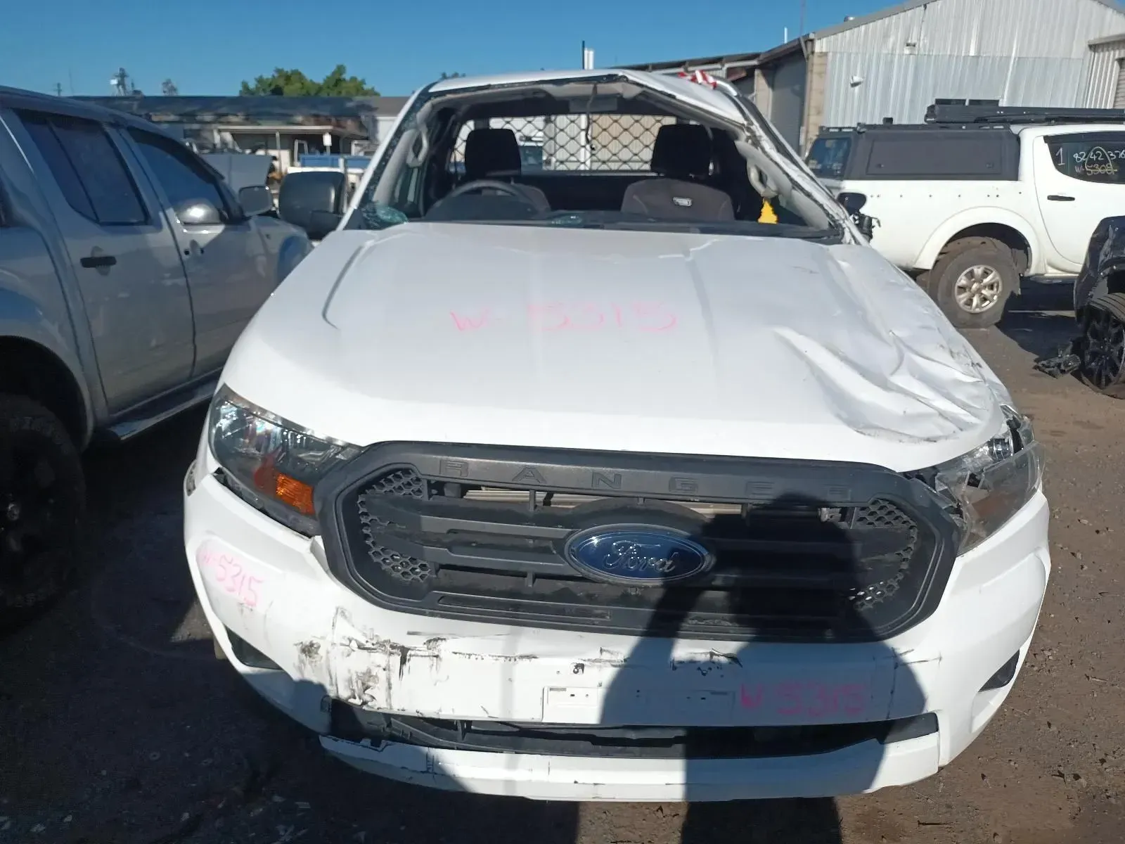 White Ford Ranger Pickup Truck With Front-end Damage in a Salvage Yard — South West 4WD Wreckers In Brisbane, QLD