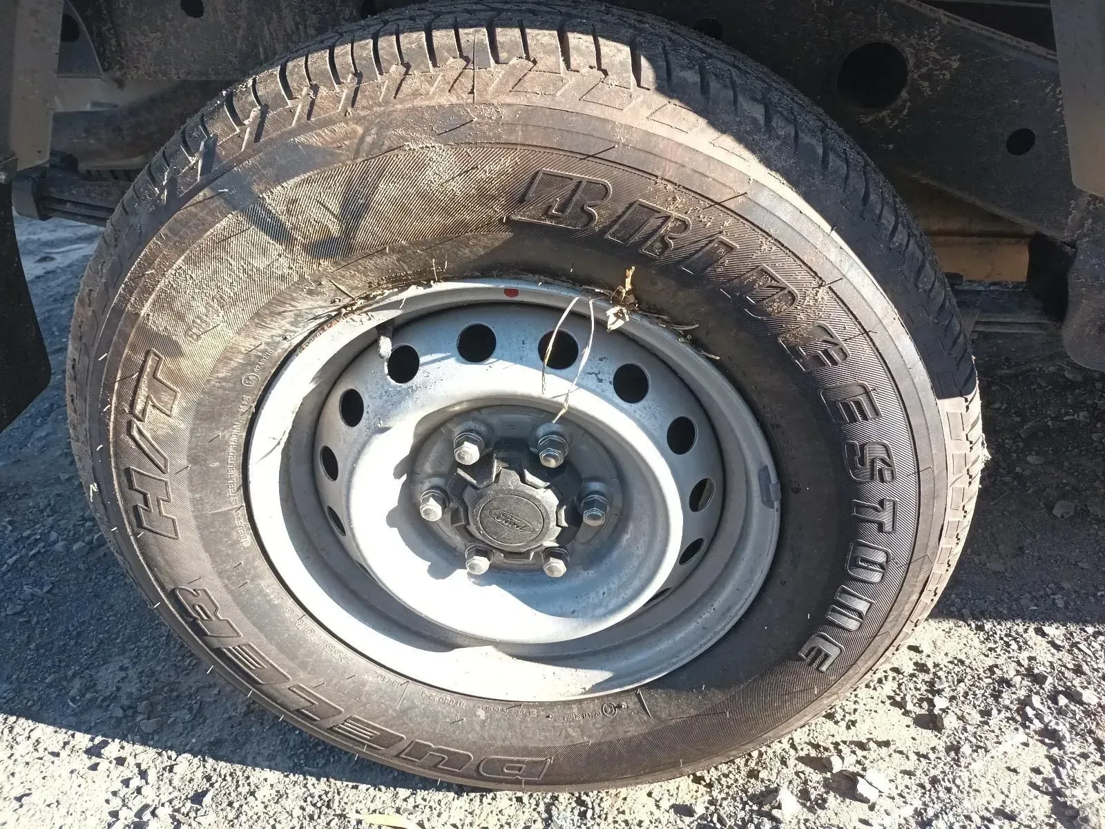 A Black Tyre on a Silver Rim With Lug Nuts, Likely on a Vehicle — South West 4WD Wreckers In Brisbane, QLD