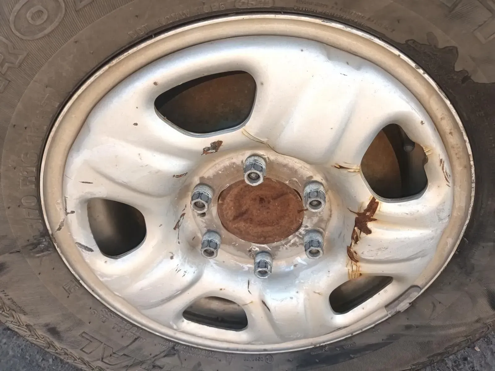 Steel Wheel With Tyre; Rim is Silver With Rust Near the Center — South West 4WD Wreckers In Brisbane, QLD