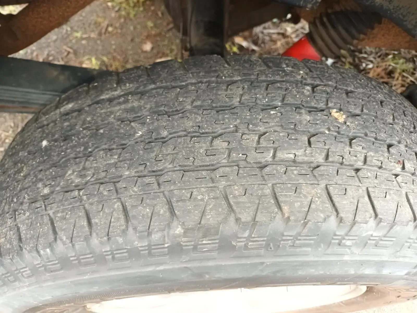 Close-up of a Worn Black Tyre With Visible Treads, Part of a Vehicle's Wheel — South West 4WD Wreckers In Brisbane, QLD