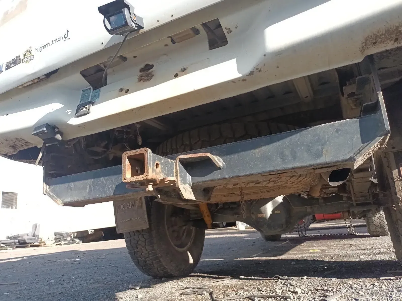 a Rusty Truck Bumper With a Trailer Hitch, Tyre, and Backup Camera — South West 4WD Wreckers In Brisbane, QLD
