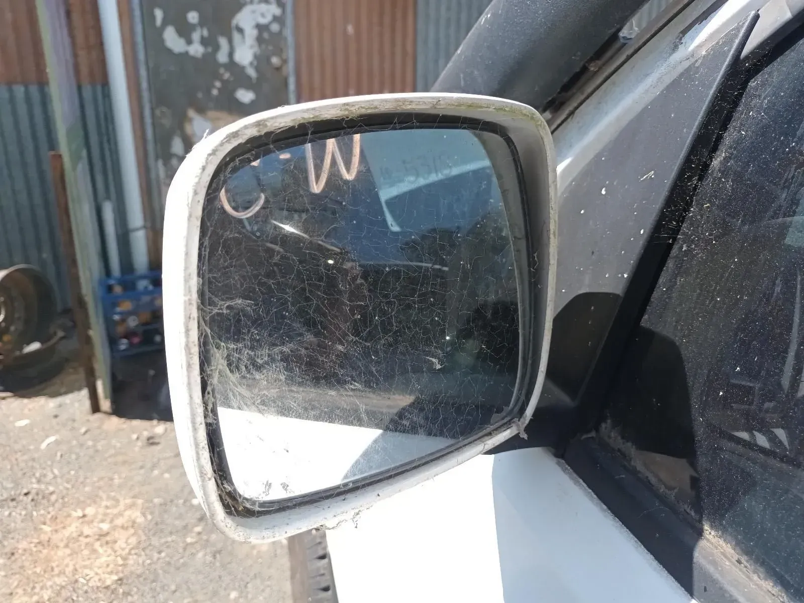 A Dusty, White Side View Mirror on a Vehicle — South West 4WD Wreckers In Brisbane, QLD