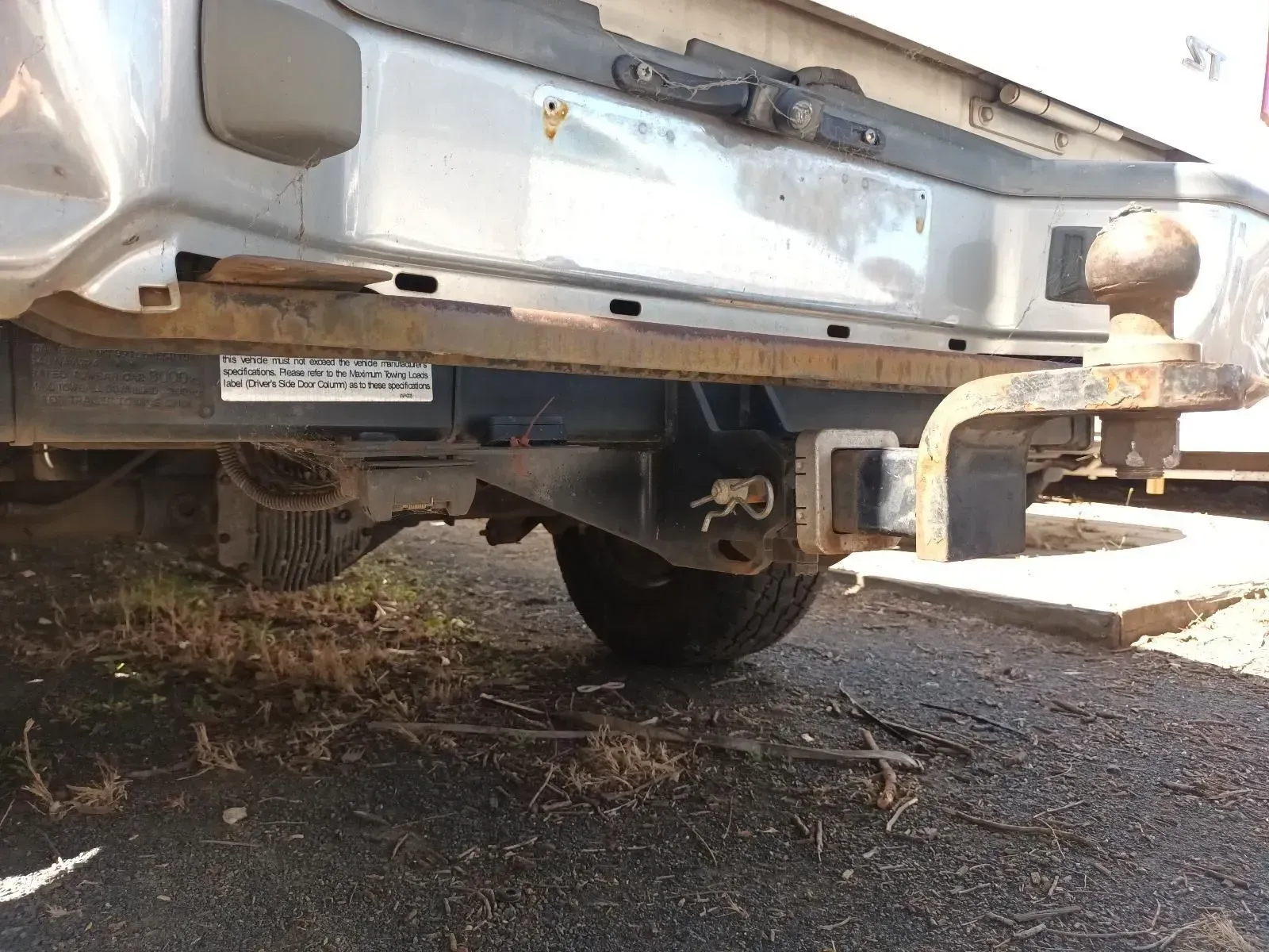 Rear of a Silver Vehicle With a Rusty Trailer Hitch and Bumper — South West 4WD Wreckers In Brisbane, QLD