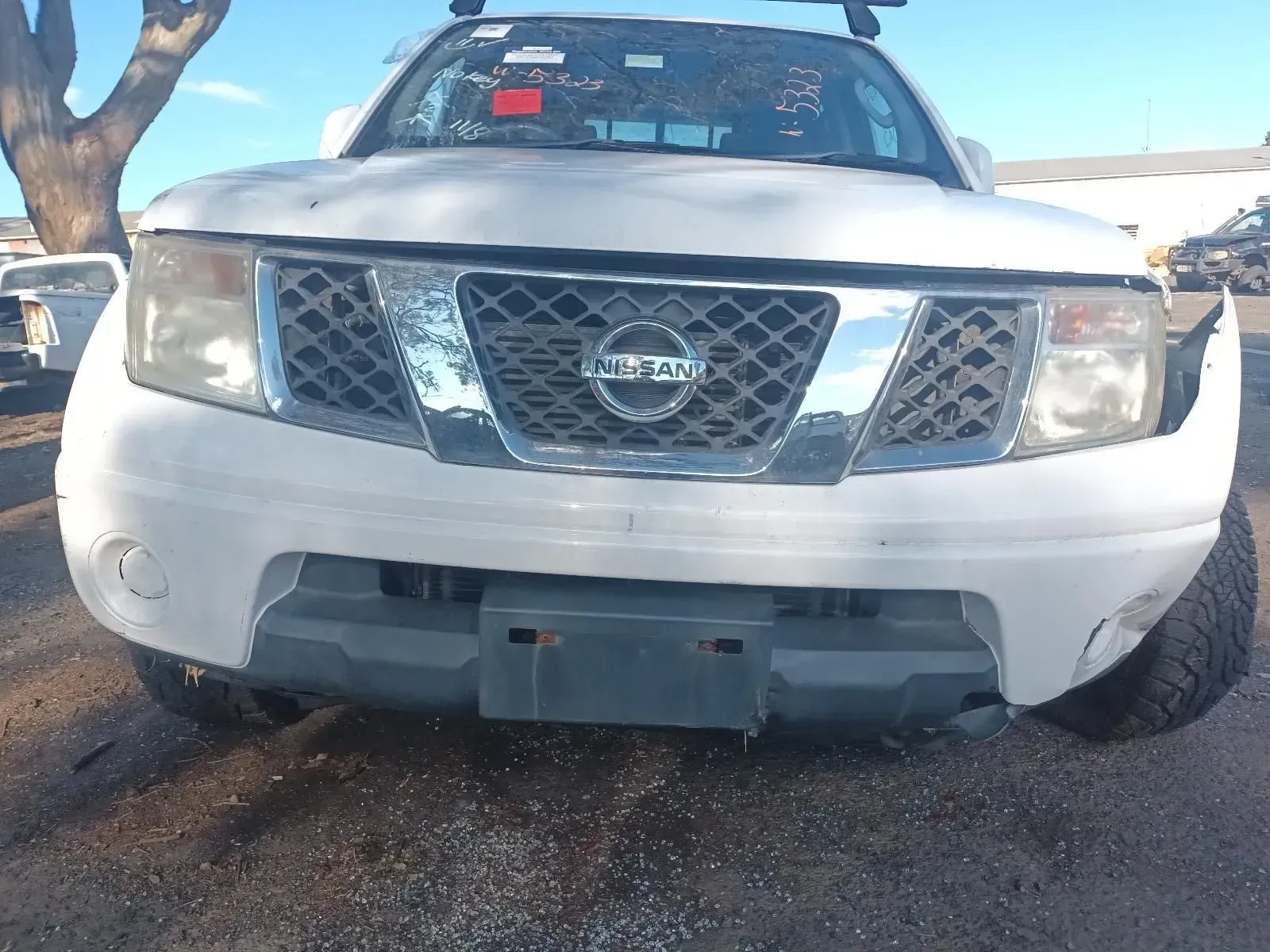 White Nissan Pickup Truck, Front View, Damaged, in a Junkyard — South West 4WD Wreckers In Brisbane, QLD