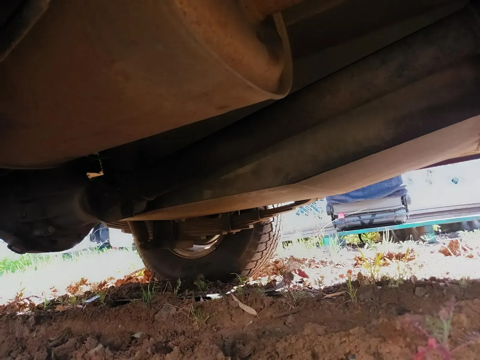 Underside of a Vehicle Showing Exhaust System Components, Suspension, and a Tyre — South West 4WD Wreckers In Brisbane, QLD