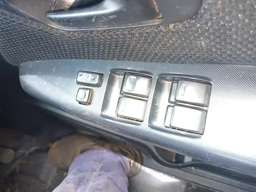 A Person is Standing Next to a Window Switch in a Car — South West 4WD Wreckers In Brisbane, QLD